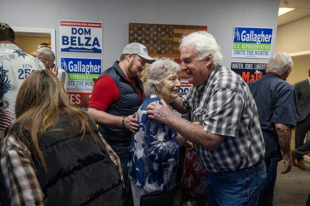 Republican Party supporters Richard Campbell and Jo Finn embrace at the Sutter County GOP headquarters in Yuba City on March 5.