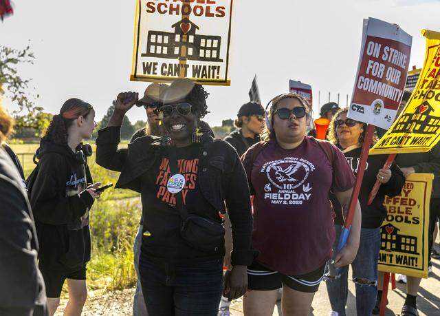 Flo Cofer, a candidate for Sacramento County Board of Supervisors, walks on Truxel Road with Natomas High School students during a walkout in support of a teachers strike on Monday.