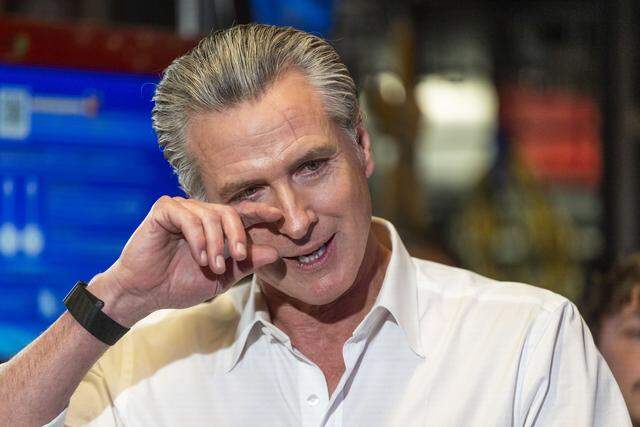 An emotional Gov. Gavin Newsom is overcome with emotion after listening to members of the California Service Corps tell stories during his visit to Shop Class, a nonprofit learning center in Sacramento's Oak Park neighborhood on Wednesday. He was helping to launch a new recruitment drive for the volunteer corps.  