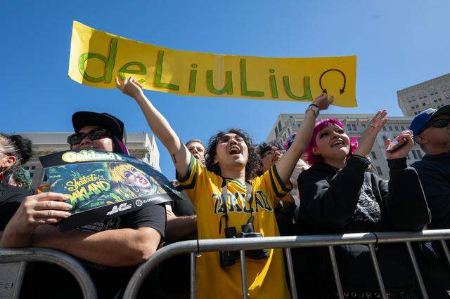 Tammy Mah Ung, Kenny Jong and April Salazar cheer during a celebration rally or Alysa Liu at Frank Ogawa Plaza in Oakland on Thursday. Thousands came out to honor Liu for her Gold Medal in Women’s Ice Skating at the Milano Cortina 2026 Olympics.