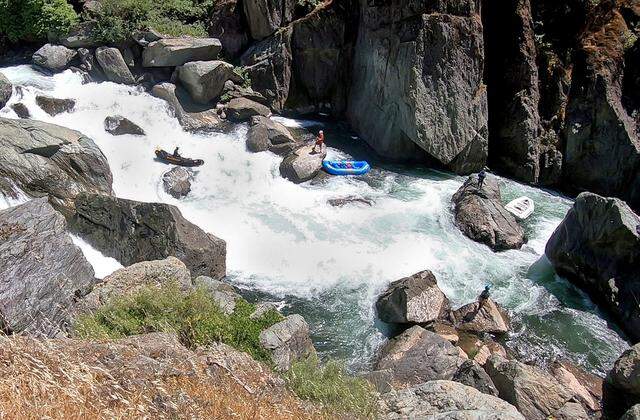 A guide with Sierra Whitewater maneuvers his raft on Ruck-A-Chucky Falls on the Middle Fork of the American River on May 24, 2024. The falls are considered too dangerous for a loaded raft, so passengers disembark and hike around the obstacle. 