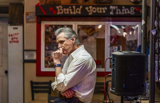 Gov. Gavin Newsom listens to participants of the California Service Corps on Wednesday during a visit to Shop Class, a nonprofit learning center in Sacramento’s Oak Park neighborhood. Newsom was launching a recruitment campaign to add 10,000 young people to the California Service Corps.