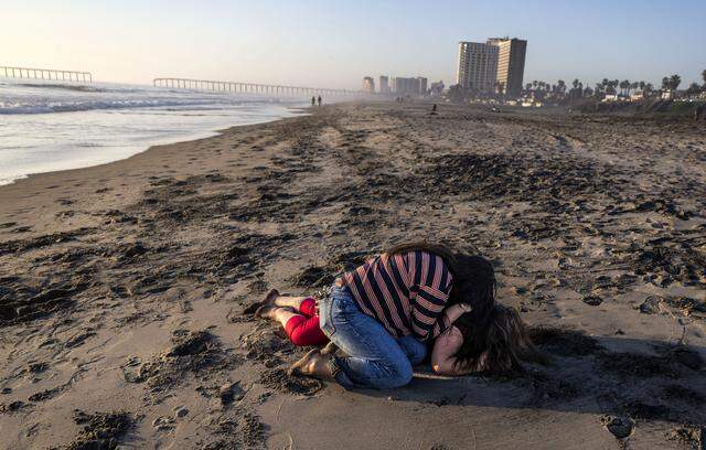 Maria de Jesus Estrada Juarez breaks down on the beach as Ivonne Rodriguez, press director at FWD.us, comforts her in Rosarito, Mexico, on Sunday, March 29, 2026. Estrada Juarez was awaiting permission to reenter the United States after a federal judge ordered the government to facilitate her return.