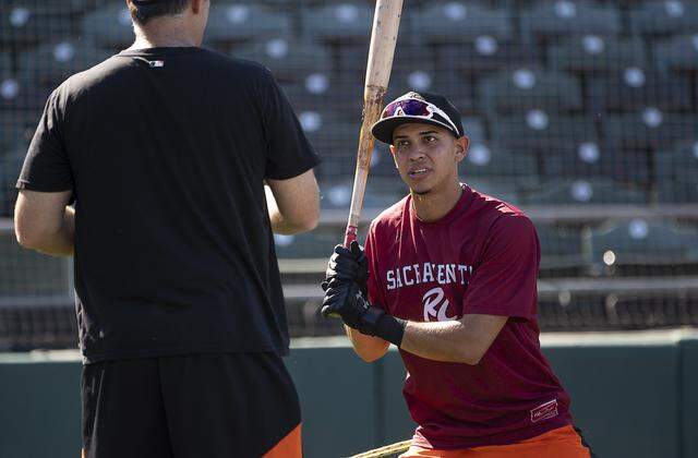 Infielder Mauricio Dubon, then of the Sacramento River Cats, talks with coach Damon Minor at Raley Field on Wednesday, Aug. 7, 2019 in West Sacramento. 