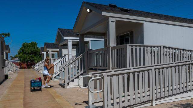 A volunteer in 2021 helps ready a new modular housing community in Sacramento. 