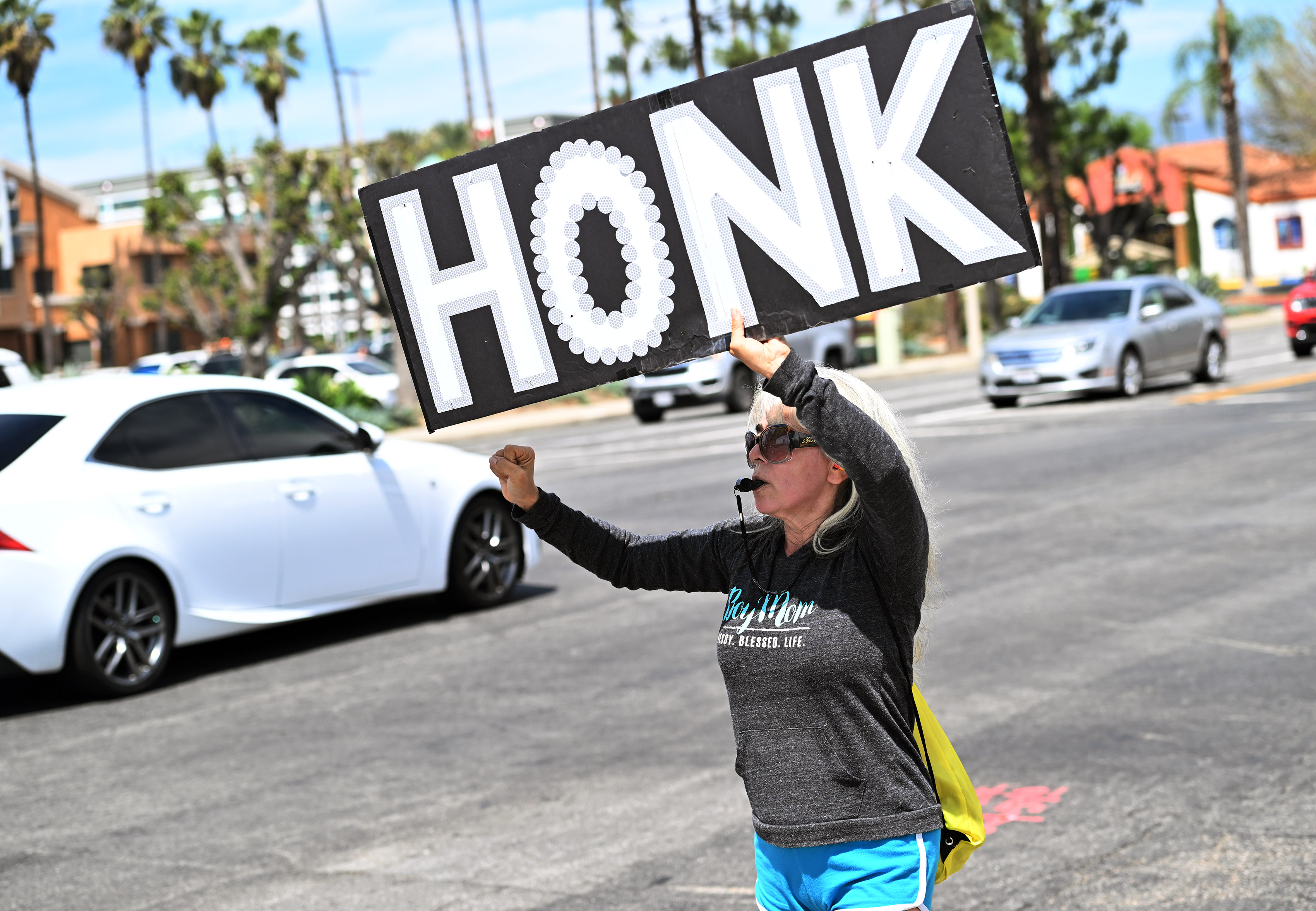 Sonia Galindo protests at the corner of North Vineyard Avenue...