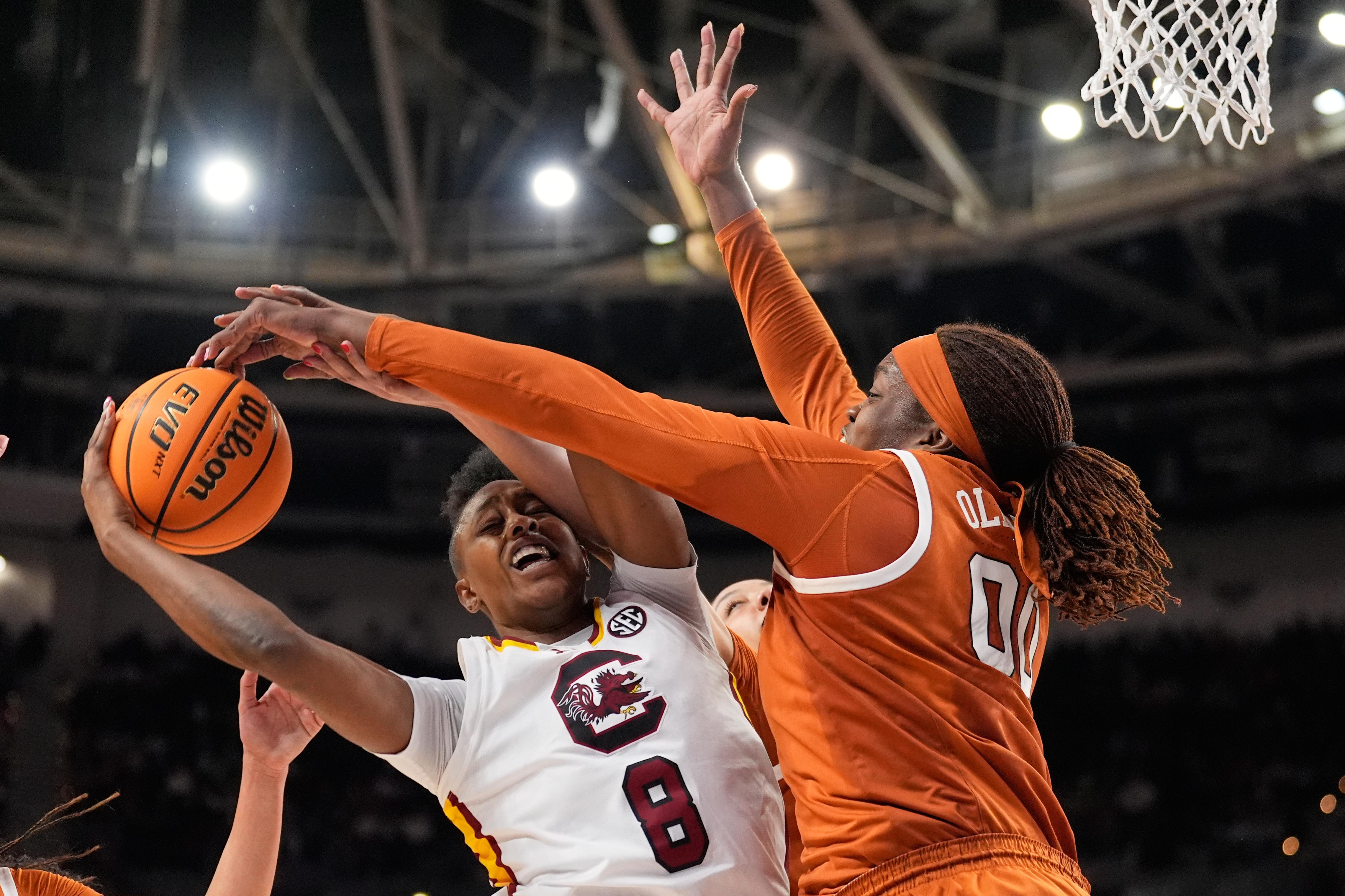 Texas center Kyla Oldacre blocks a shot by South Carolina...