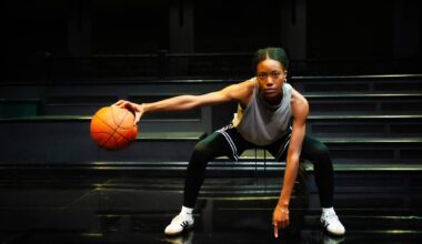 A young woman palms a basketball.