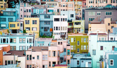 Homes packed together tightly on a hillside in a variety of vibrant colors.