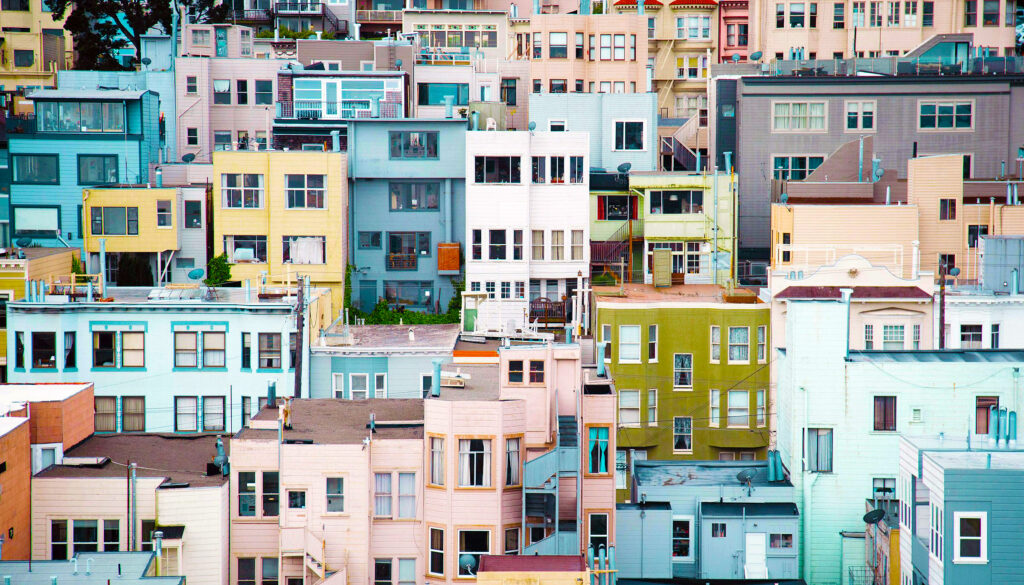 Homes packed together tightly on a hillside in a variety of vibrant colors.