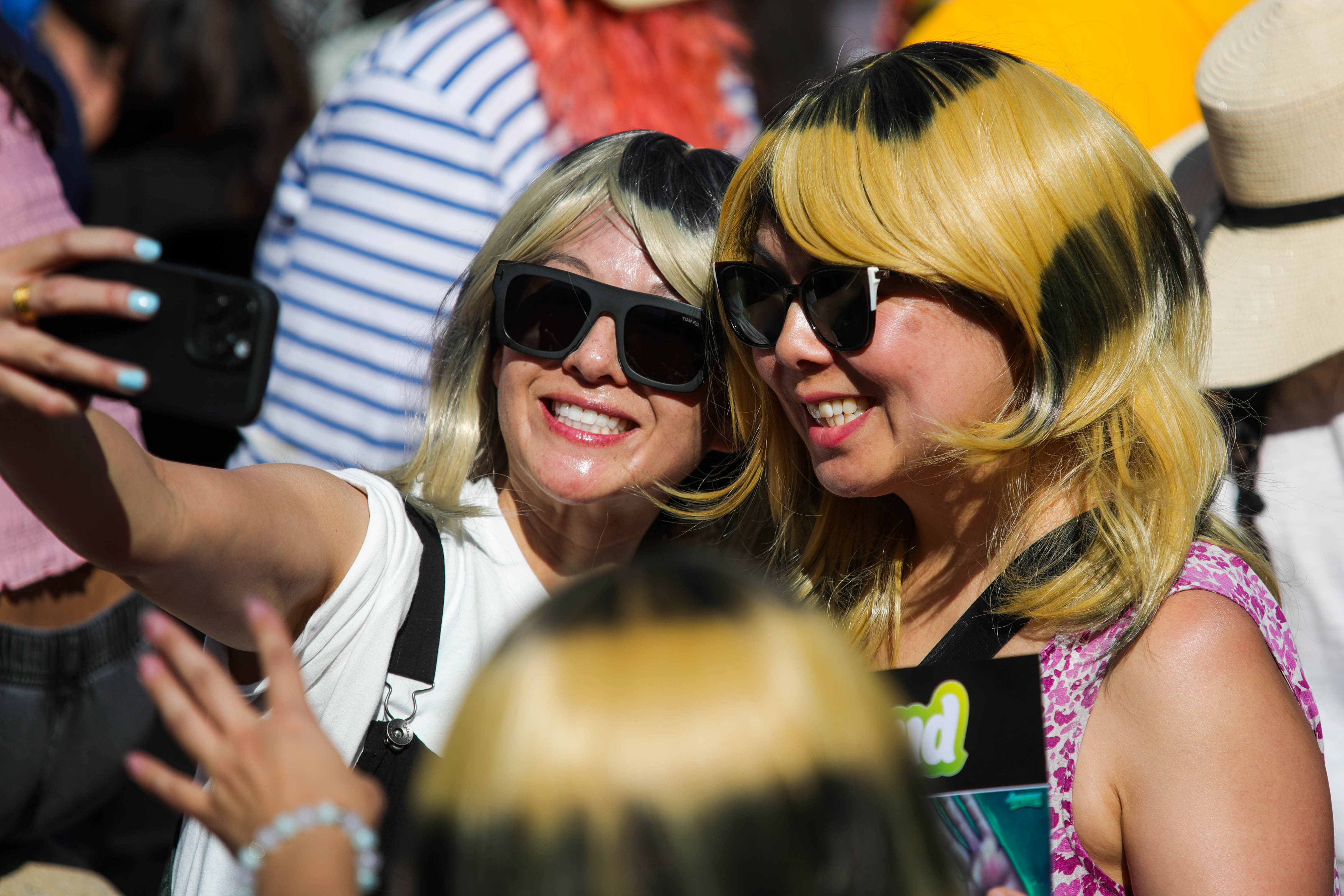Attendees wear wigs matching Alysa Liuâs hairstyle during the Alysa...