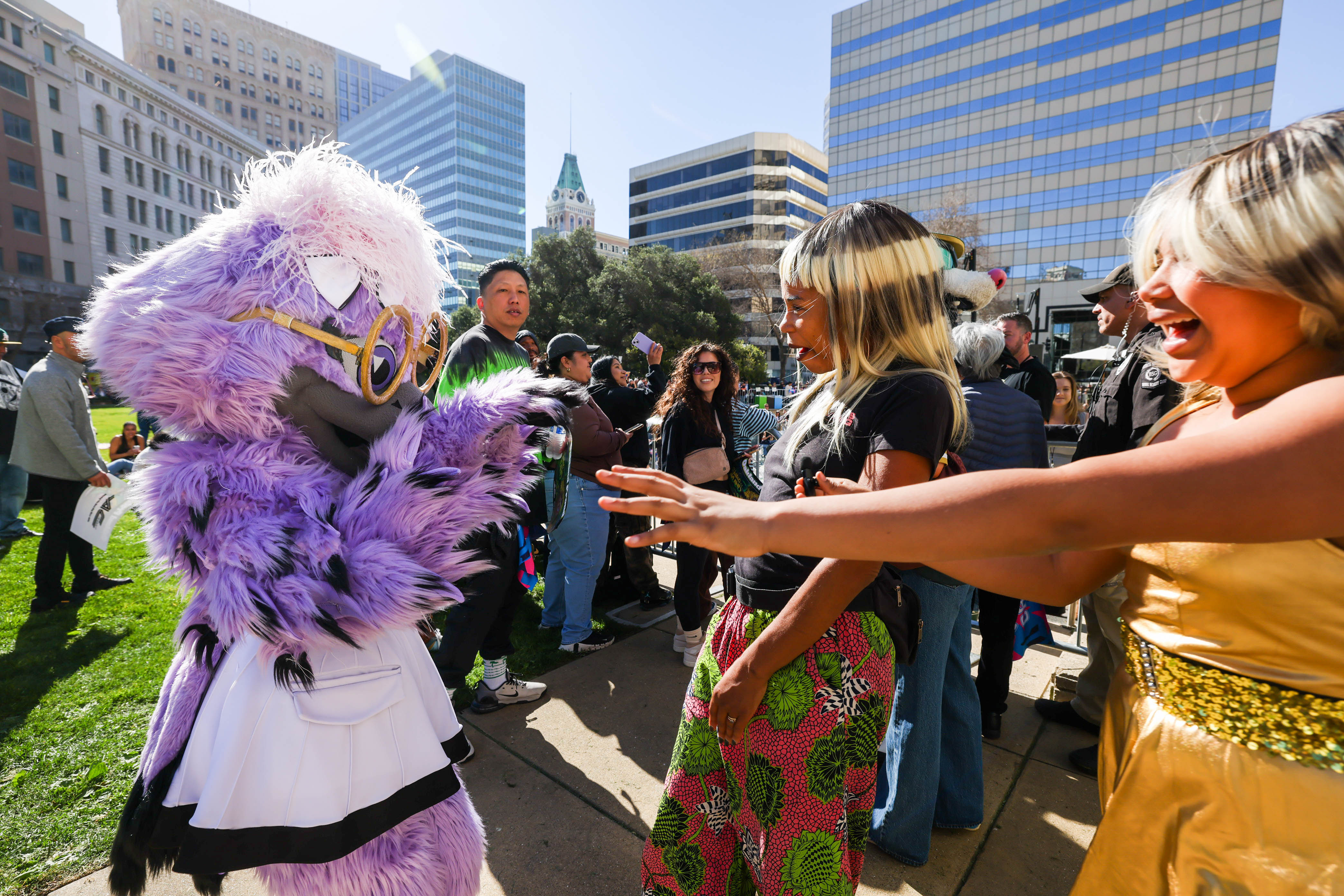 Golden State Valkyries mascot Violet, left, greets Savannah Shange, center,...