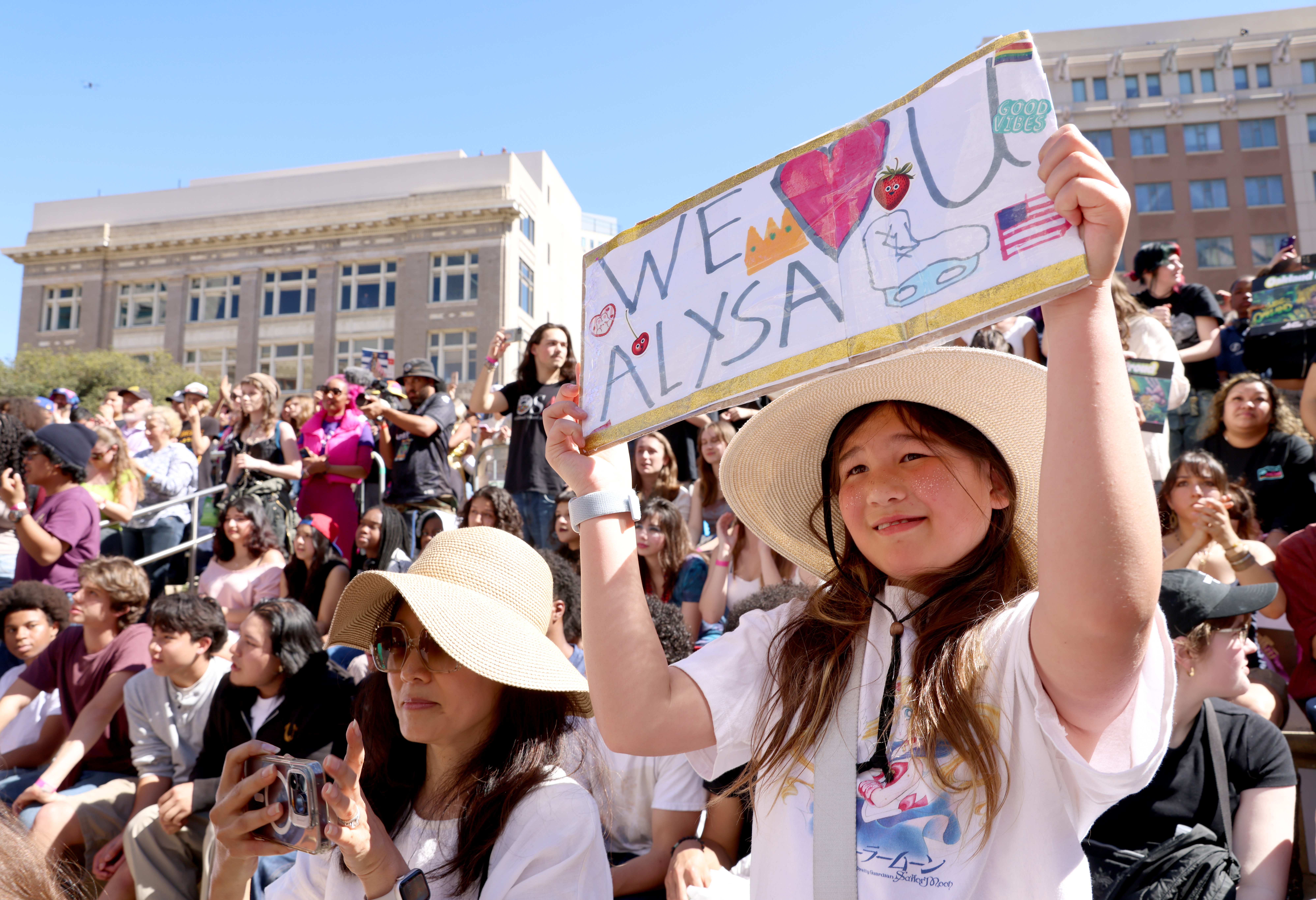 Ellie Fenno, 11, of San Francisco, hoists a sign during...