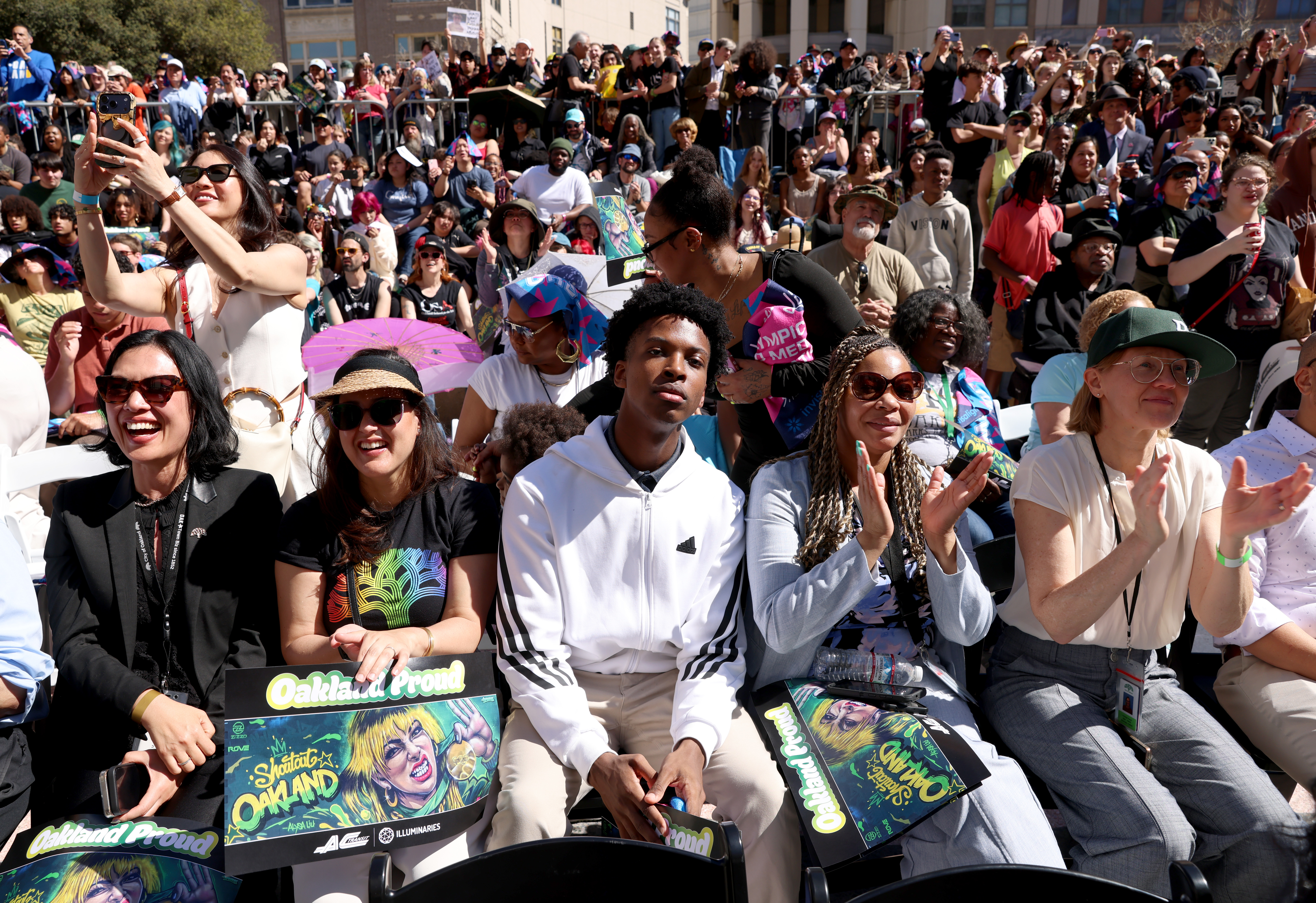People applaud during a celebration for Olympic double gold medal...