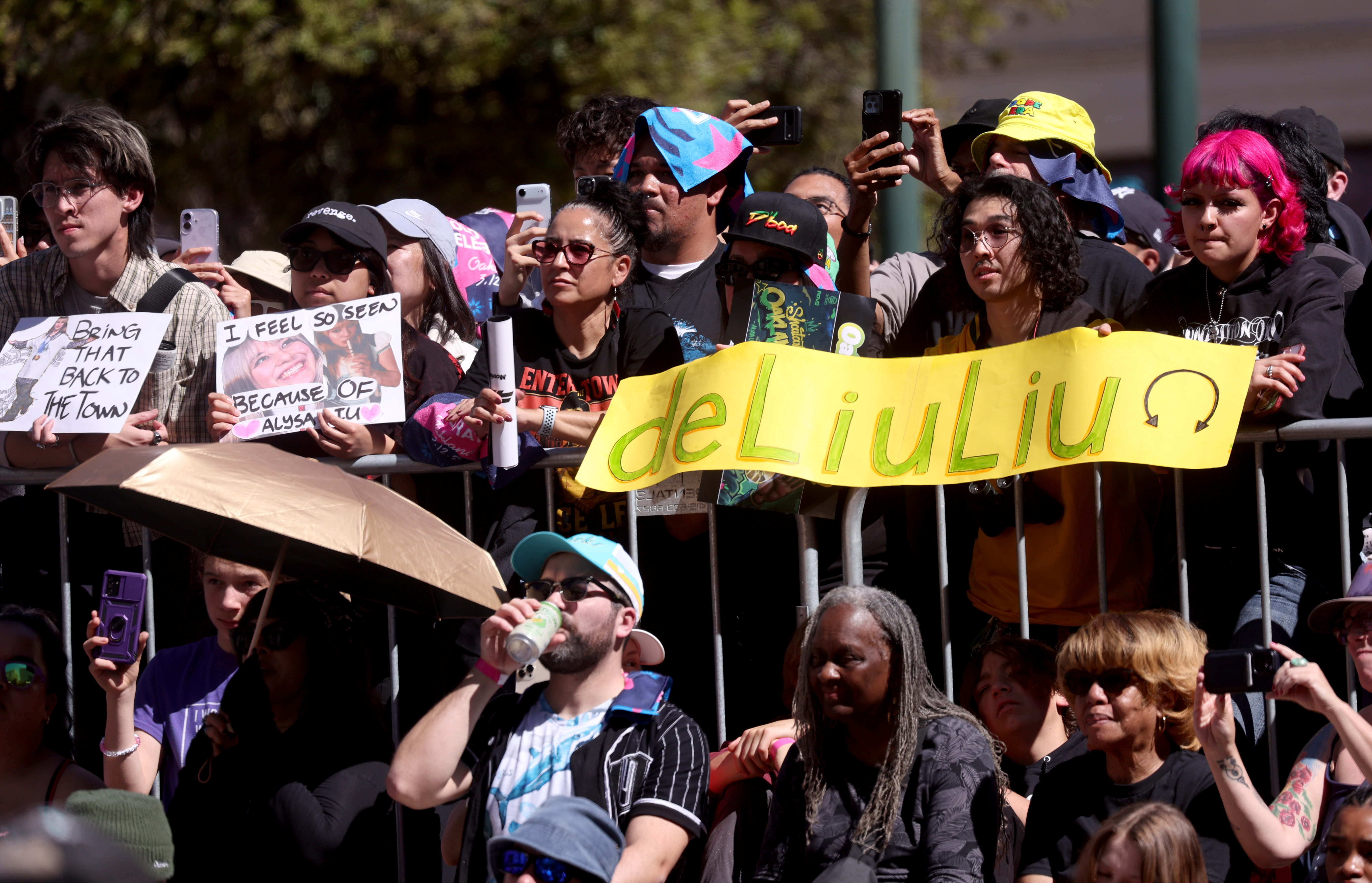 People display their signs during a celebration for Olympic double...