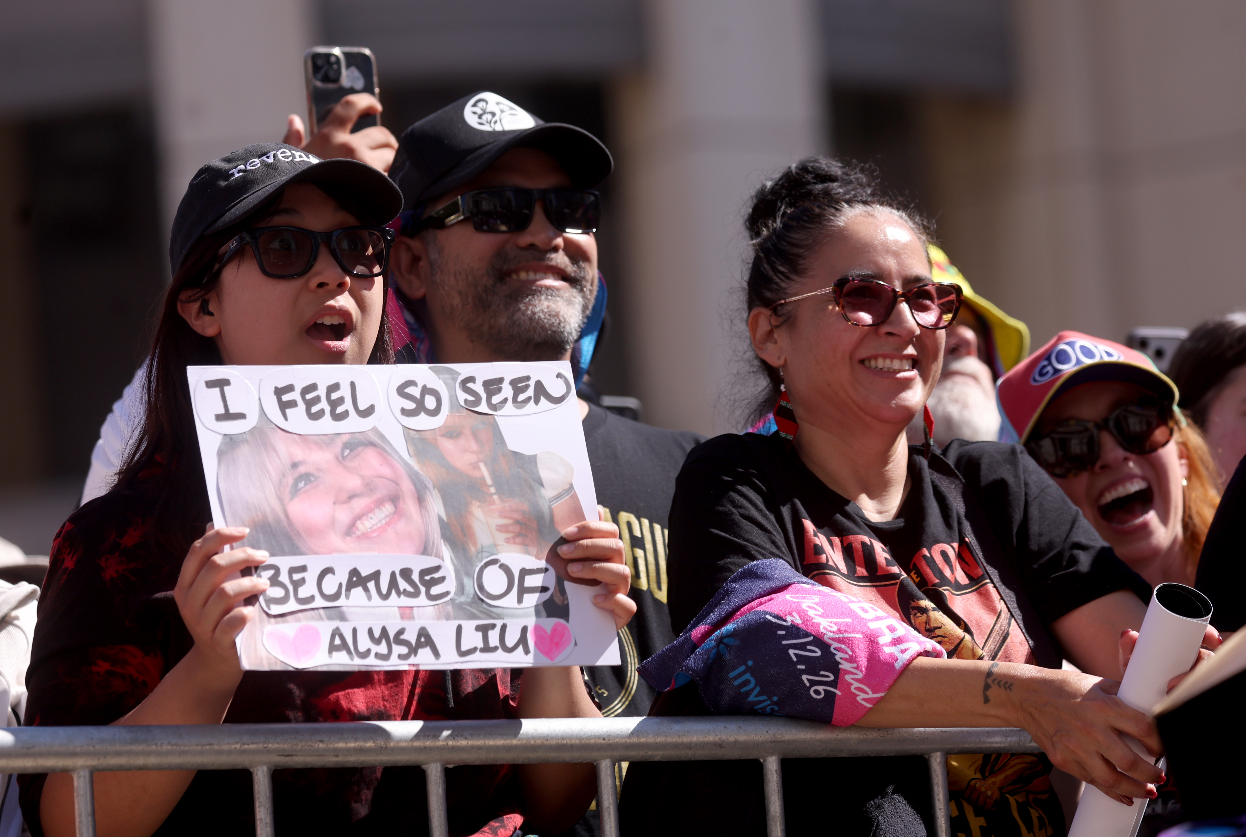People display their signs during a celebration for Olympic double...