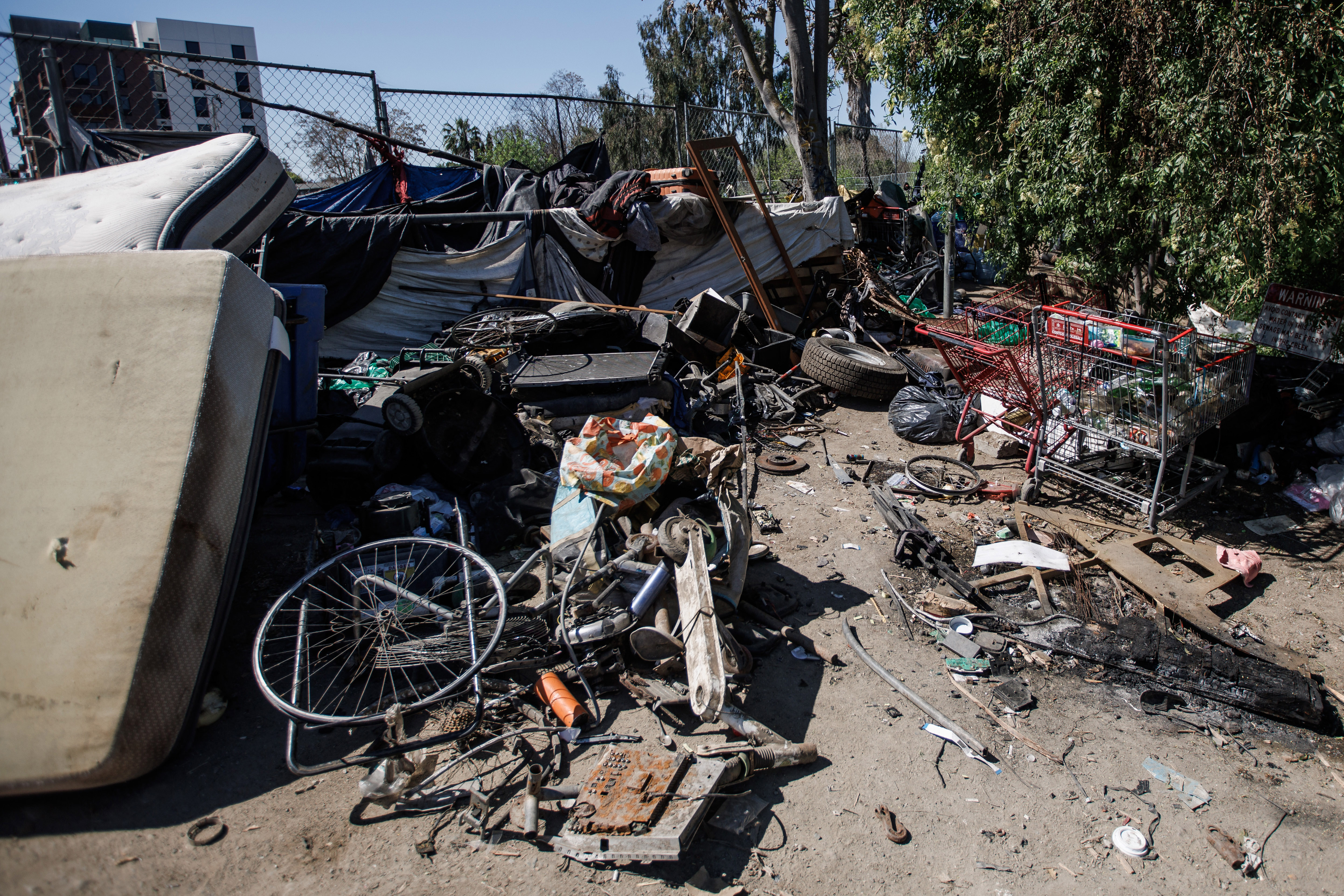 Trash is piled up at an entrance to âThe Jungleâ...