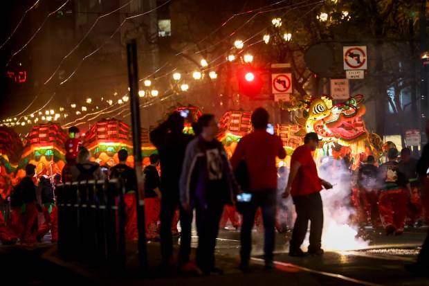 Firecrackers light up Market Street as participants perform a dragon dance during the Chinese New Year Parade, celebrating the Year of the Horse, in San Francisco, Calif., on Saturday, March 7, 2026. (Ray Chavez/Bay Area News Group)