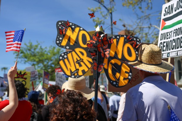 A person carries a sign during a No Kings protest in downtown San Jose, Calif., on Saturday, March 28, 2026. (Shae Hammond/Bay Area News Group)