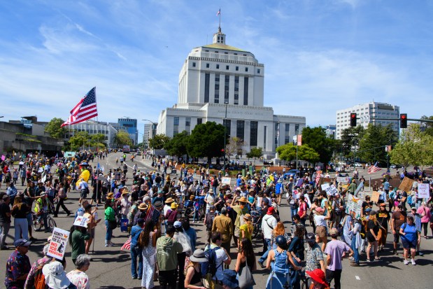 Protesters march past the Alameda County Court House during the No Kings Protest in Oakland, Calif., on Saturday, March 28, 2026. (Jose Carlos Fajardo/Bay Area News Group)