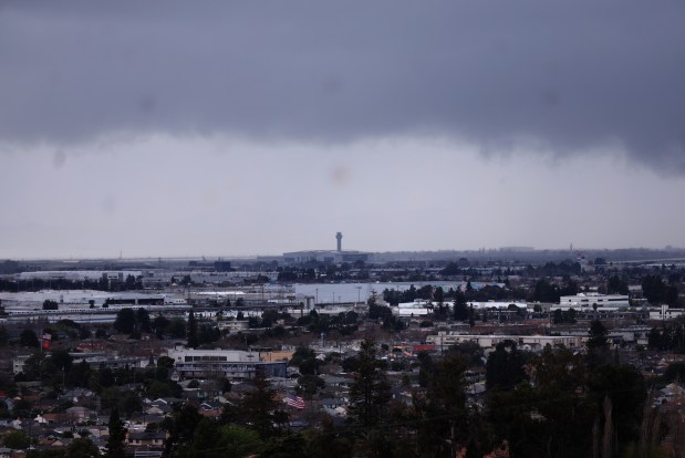 Storm clouds are seen over the Oakland San Francisco Bay Airport in a view from San Leandro, Calif., on Wednesday, Feb. 11, 2026. More rain is forecast for the weekend. (Jane Tyska/Bay Area News Group)
