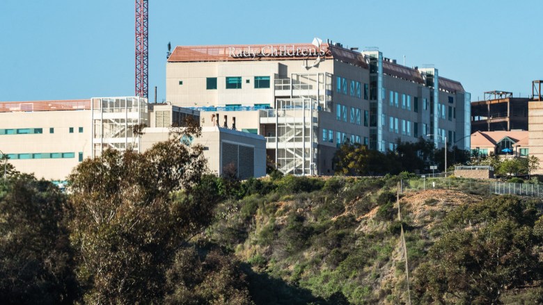 A building on a hilltop rise as seen from a distance.