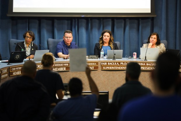 San Diego Unified Superintendent Fabiola Bagula, second from right, and board members Sharon Whitehurst-Payne, Richard Barrera and Sabrina Bazzo listen to people speak out against the decision to lay off classified workers at the San Diego Unified School District headquarters on Tuesday, March 3, 2026. (Kristian Carreon / The San Diego Union-Tribune)