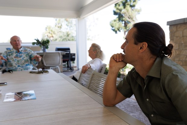 Landscape architect Ari Tenenbaum, right, speaks with his clients and homeowners Steve and Beth Elliott at their Encinitas home. (Kristian Carreon / The San Diego Union-Tribune)