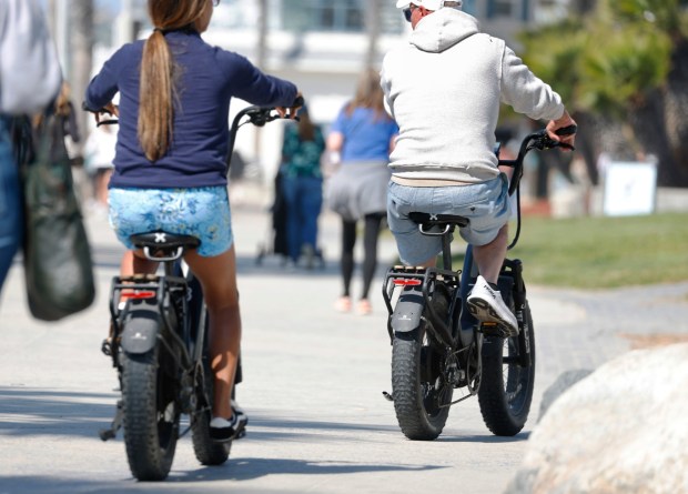 People ride e-bikes in Pacific Beach on March 4, 2026 in San Diego, CA. (K.C. Alfred / The San Diego Union-Tribune)