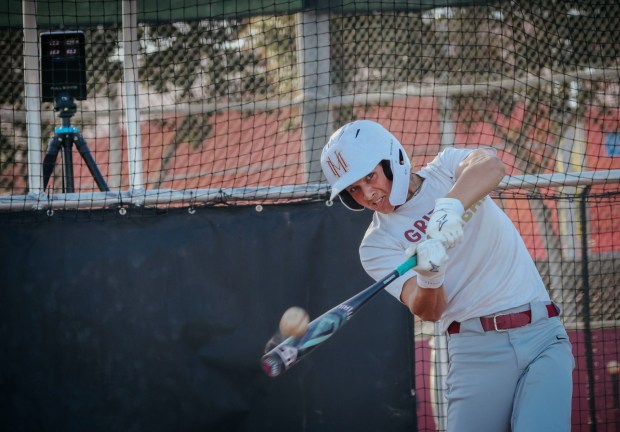 Player Noah Litchfield takes batting practice while a Full Swing device back Left, records stats on Monday, February 23, 2026 at Mission Hills H.S. in San Marcos. The device records sevral batting statistics that are a boon to player improvement and a boon to recruiters. (Sandy Huffaker / For The San Diego Union-Tribune)