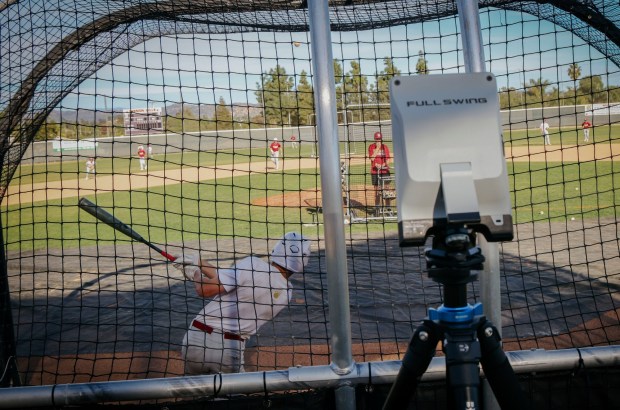 Players take batting practice while a Full Swing machine records stats on Monday, February 23, 2026 at Mission Hills H.S. in San Marcos. The device records sevral batting statistics that are a boon to player improvement and a boon to recruiters. (Sandy Huffaker / For The San Diego Union-Tribune)