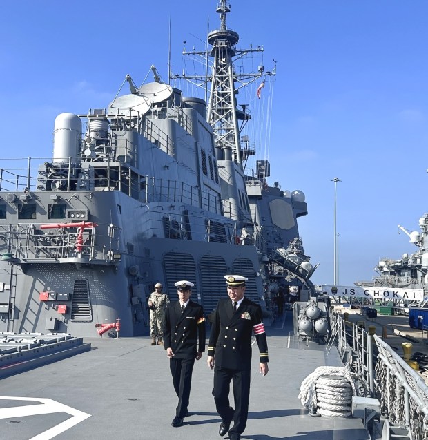 Officers walk across the desk of the Japanese destroyer JS Chokai on Thursday at Naval Base San Diego. (Gary Robbins / The San Diego Union-Tribune)