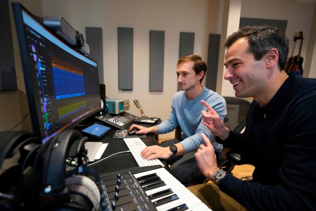 Mikey Shulman, at right, is one of the founders of the AI music generator company Suno. He is shown with research scientist Christian Steinmetz as the two collaborate on creating a song at Suno's headquarters in Cambridge, Mass. (AP Photo / Robert F. Bukaty)