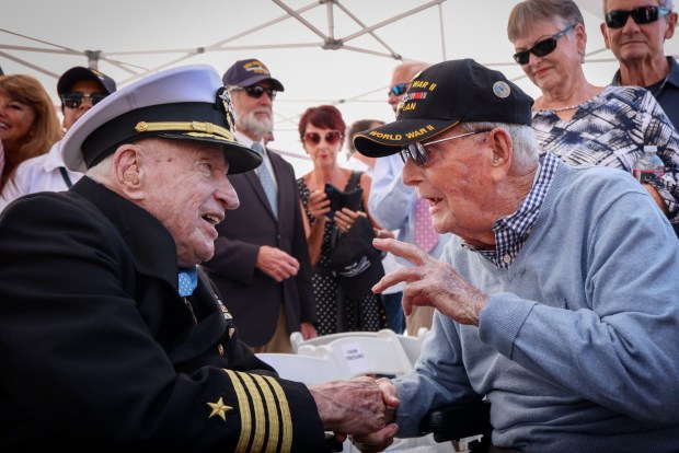 Capt. Royce Williams shares a moment with Sgt Walter Travis, the oldest living Marine, aboard the USS Midway museum during a Medal of Honor ceremony on Saturday, March 21, 2026. The ceremony payed tribute to Capt. Williams, a decorated U.S. Navy fighter pilot, who demonstrated extraordinary courage and superior airmanship, during an aerial combat mission during the Korean War nearly 74 years ago. (Sandy Huffaker / For The San Diego Union-Tribune)