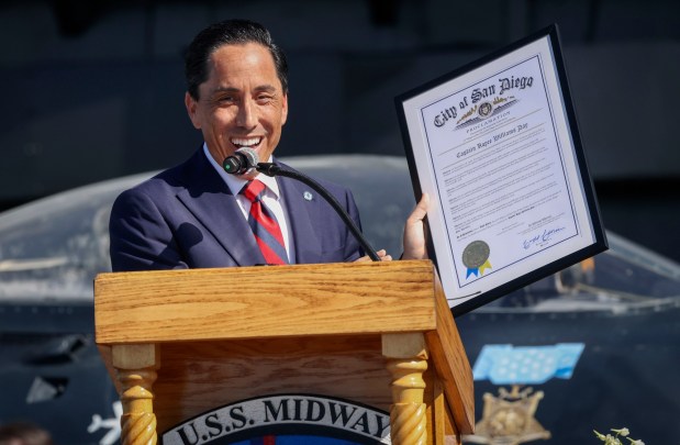 Mayor Todd Gloria presents a declaration to name Capt. Royce Williams Day aboard the USS Midway museum during a Medal of Honor ceremony on Saturday, March 21, 2026. The ceremony payed tribute to Capt. Williams, a decorated U.S. Navy fighter pilot, who demonstrated extraordinary courage and superior airmanship, during an aerial combat mission during the Korean War nearly 74 years ago. (Sandy Huffaker / For The San Diego Union-Tribune)
