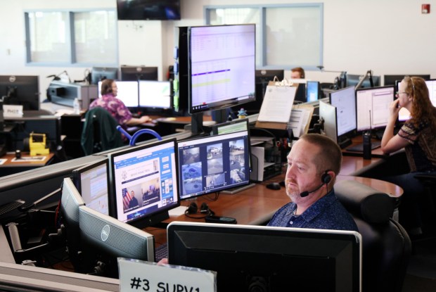 911 operator J.J. Buie works the floor at the Sheriff Office's Emergency Response Center on Wednesday. (Sandy Huffaker / For The San Diego Union-Tribune)