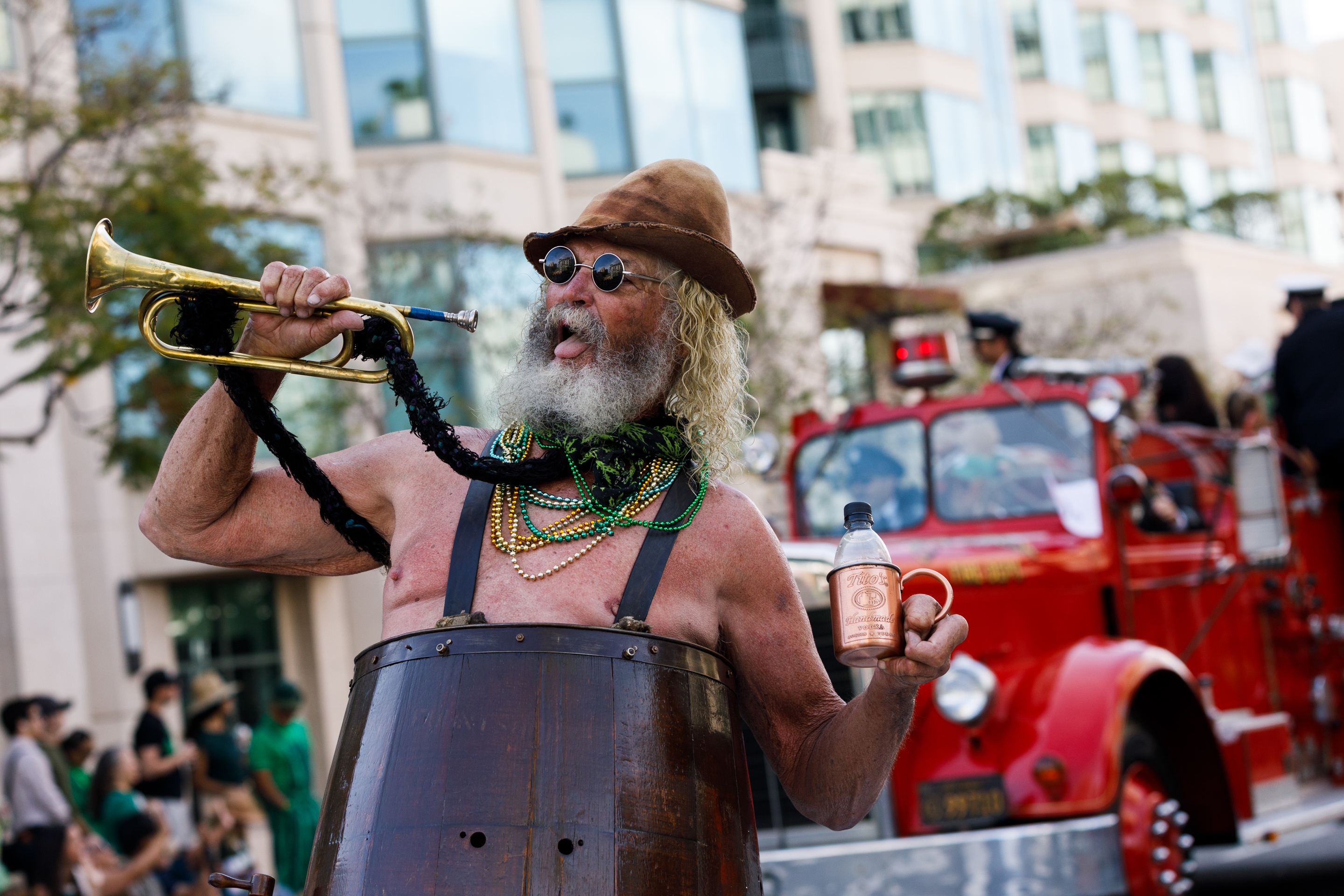 A man dressed in a wooden barrel participates in the...
