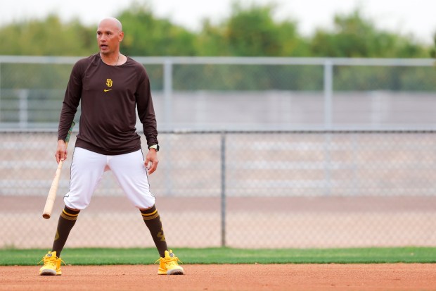 San Diego Padres infield instructor Ryan Goins watches drills during spring training workouts at the Peoria Sports Complex on Friday, Feb. 13, 2026 in Peoria, Ariz.. (Meg McLaughlin / The San Diego Union-Tribune)