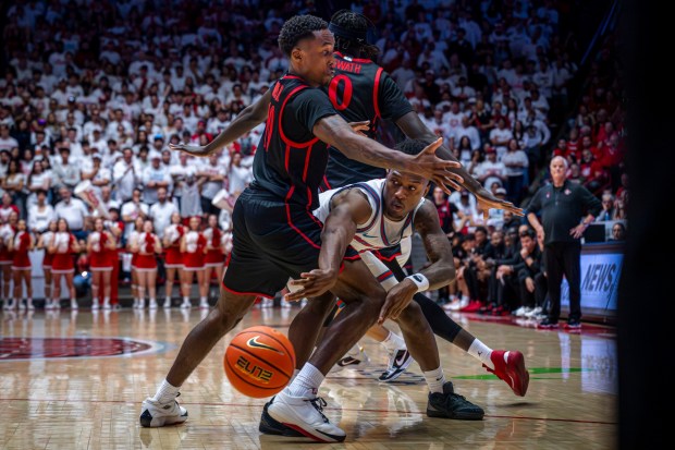 Lobos guard Deyton Albury, right, passes the ball around San Diego State guard BJ Davis at the Pit on Friday, Feb. 28, 2026. (Jessica Baca, The Albuquerque Journal)
