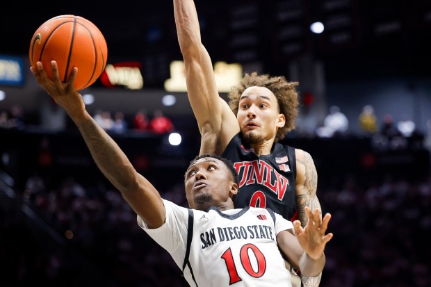 BJ Davis #10 of San Diego State goes up for a shot against Dra Gibbs-Lawhorn #0 of UNLV at Viejas Arena on Friday, March 6, 2026 in San Diego, California. (Meg McLaughlin / The San Diego Union-Tribune)
