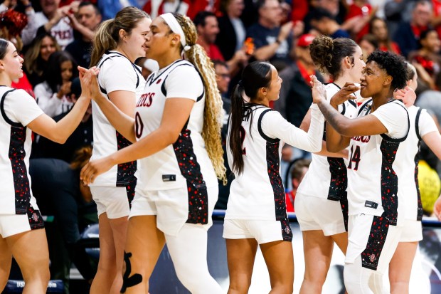San Diego State players celebrate after defeating UC Irvine during the first round of the WBIT at Jenny Craig Pavilion on Thursday, March 19, 2026 in San Diego, California. (Meg McLaughlin / The San Diego Union-Tribune)