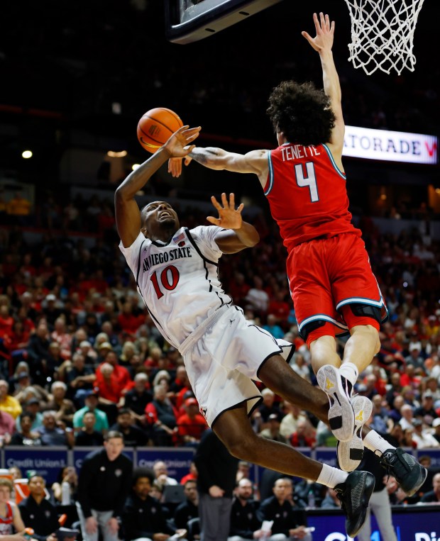 BJ Davis #10 of San Diego State has a shot blocked by Uriah Tenette #4 of New Mexico in the semifinals of the Mountain West Conference basketball tournament at the Thomas & Mack Center on March 13, 2026 in Las Vegas, NV. (K.C. Alfred / The San Diego Union-Tribune)