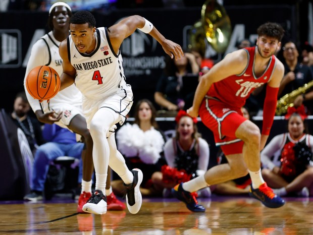 Sean Newman Jr. #4 of San Diego State steals the ball from Tomislav Buljan #10 of New Mexico in the semifinals of the Mountain West Conference basketball tournament at the Thomas & Mack Center on March 13, 2026 in Las Vegas, NV. (K.C. Alfred / The San Diego Union-Tribune)