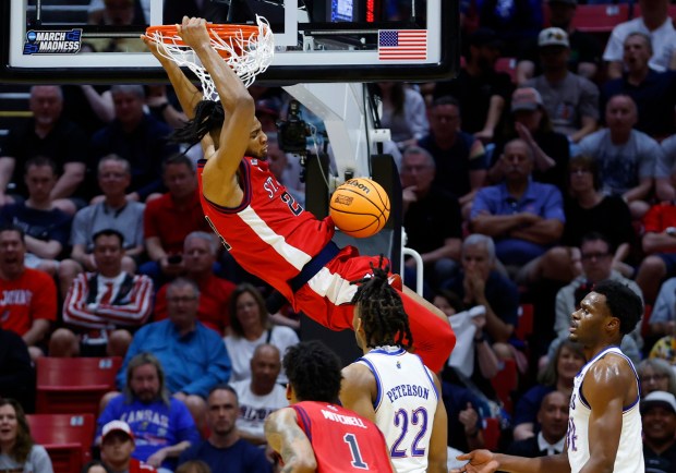 Zuby Ejiofor #24 of St. John's dunks as Paul Mbiya #34 of Kansas looks on during the second round of the NCAA Men's Basketball Tournament at Viejas Arena on March 22, 2026 in San Diego, CA.(K.C. Alfred / The San Diego Union-Tribune)