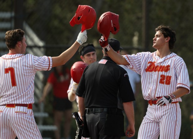 Cathedral Catholic's Max Stewart, right, and Trey Kotsay celebrate Stewart's two -run home run against Granite Hills in the third inning at Cathedral Catholic High School in San Diego on Friday, March 13, 2026. (Hayne Palmour IV / For The San Diego Union-Tribune)