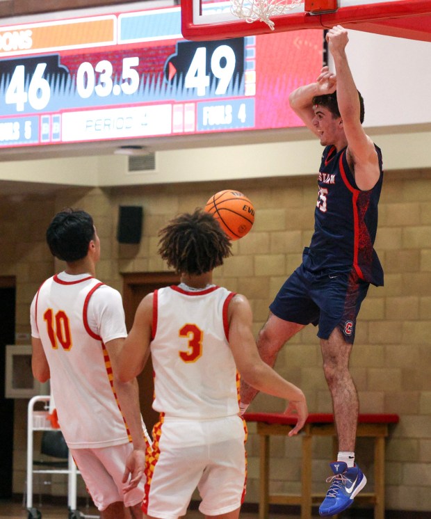 Cathedral Catholic's Charlie Barajas, left, and Seimir Roberson watch as Christian's Julian Lebel celebrates after dunking the ball in the final seconds of the game to defeat Cathedral Catholic 51-46 during the CIF Southern California Regionals Division 2 boys basketball game at Cathedral Catholic High School in sSan Diego on Tuesday, March 03, 2026. (Hayne Palmour IV / For The San Diego Union-Tribune)