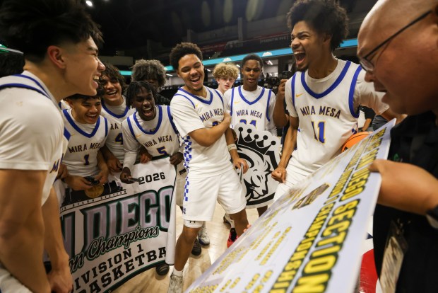The Mira Mesa High boys basketball team celebrates their CIF Division 1 championship win against Christian High at Frontwave Arena in Oceanside on Saturday, Feb. 28, 2026. The Marauders defeated the Patriots 63-55. (Kristian Carreon / The San Diego Union-Tribune)