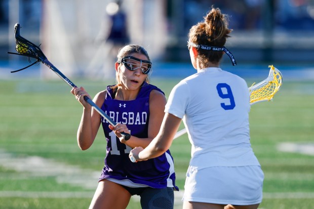 Carlsbad's Layla Munoz looks to pass against La Jolla Country Day's Evy Nadi at La Jolla Country Day High School on Wednesday, March 18, 2026 in San Diego, California. (Meg McLaughlin / The San Diego Union-Tribune)