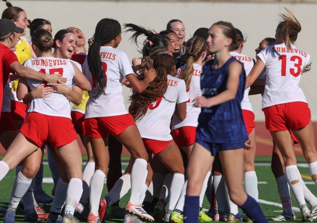 ESCONDIDO, CA - February 28, 2026: As a San Marcos player walks off the field, Mt. Carmel players celebrate beating San Marcos with penalty kicks to win the CIF Open Division girls soccer championship at Escondido High School in Escondido on Saturday, February 28, 2026. (Hayne Palmour IV / For The San Diego Union-Tribune)