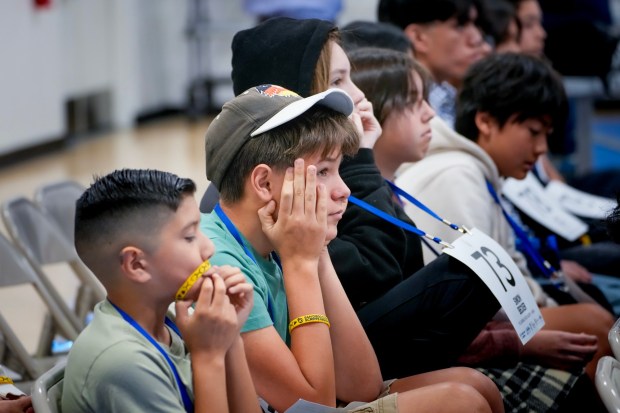 Students nervously wait their turn to take to the stage. (Nelvin C. Cepeda / The San Diego Union-Tribune)